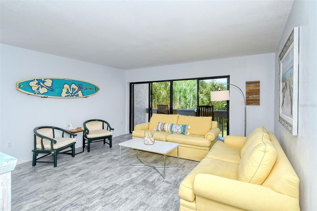 450 Beach Road, Unit 5 Sarasota, FL 34242 - Photo 6 of 59 Living room with porch overlooking the Gulf of Mexico.