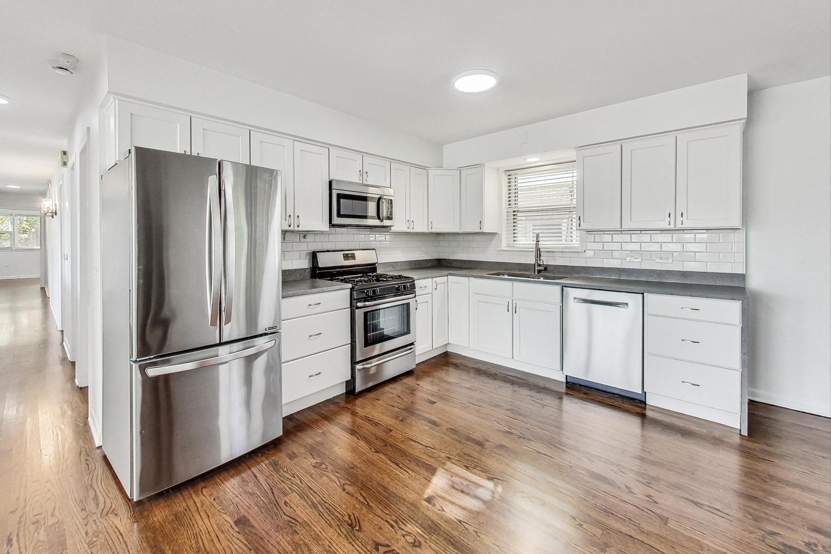 1108 Fortuna Avenue, Unit 1 Park Ridge, IL 60068 - Photo 11 of 39 a kitchen with white cabinets stainless steel appliances and wooden floor