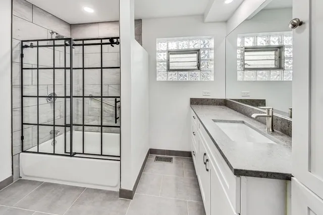 a kitchen with a sink a window and cabinets