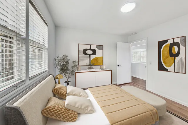 a bedroom with a bed and a window