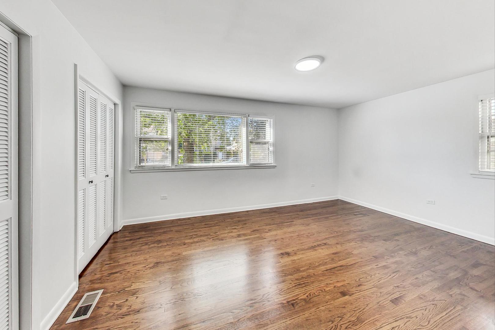 1108 Fortuna Avenue, Unit 1 Park Ridge, IL 60068 - Photo 27 of 39 an empty room with wooden floor and windows