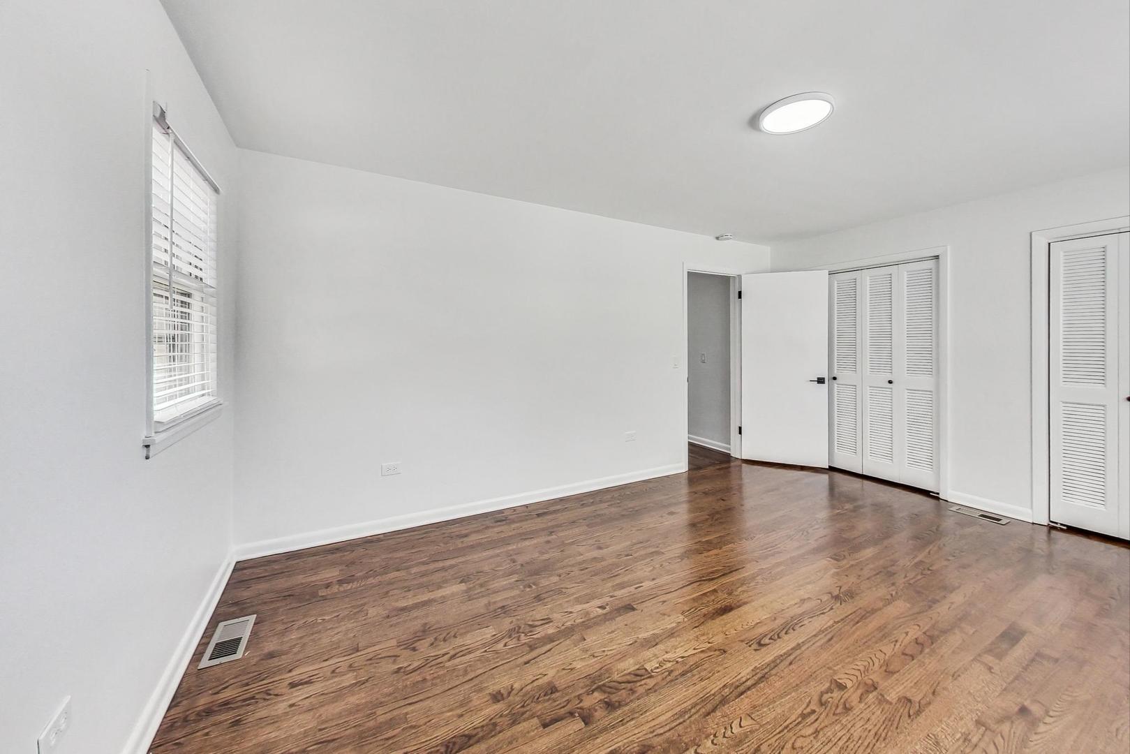 1108 Fortuna Avenue, Unit 1 Park Ridge, IL 60068 - Photo 28 of 39 a view of an empty room with wooden floor and a window