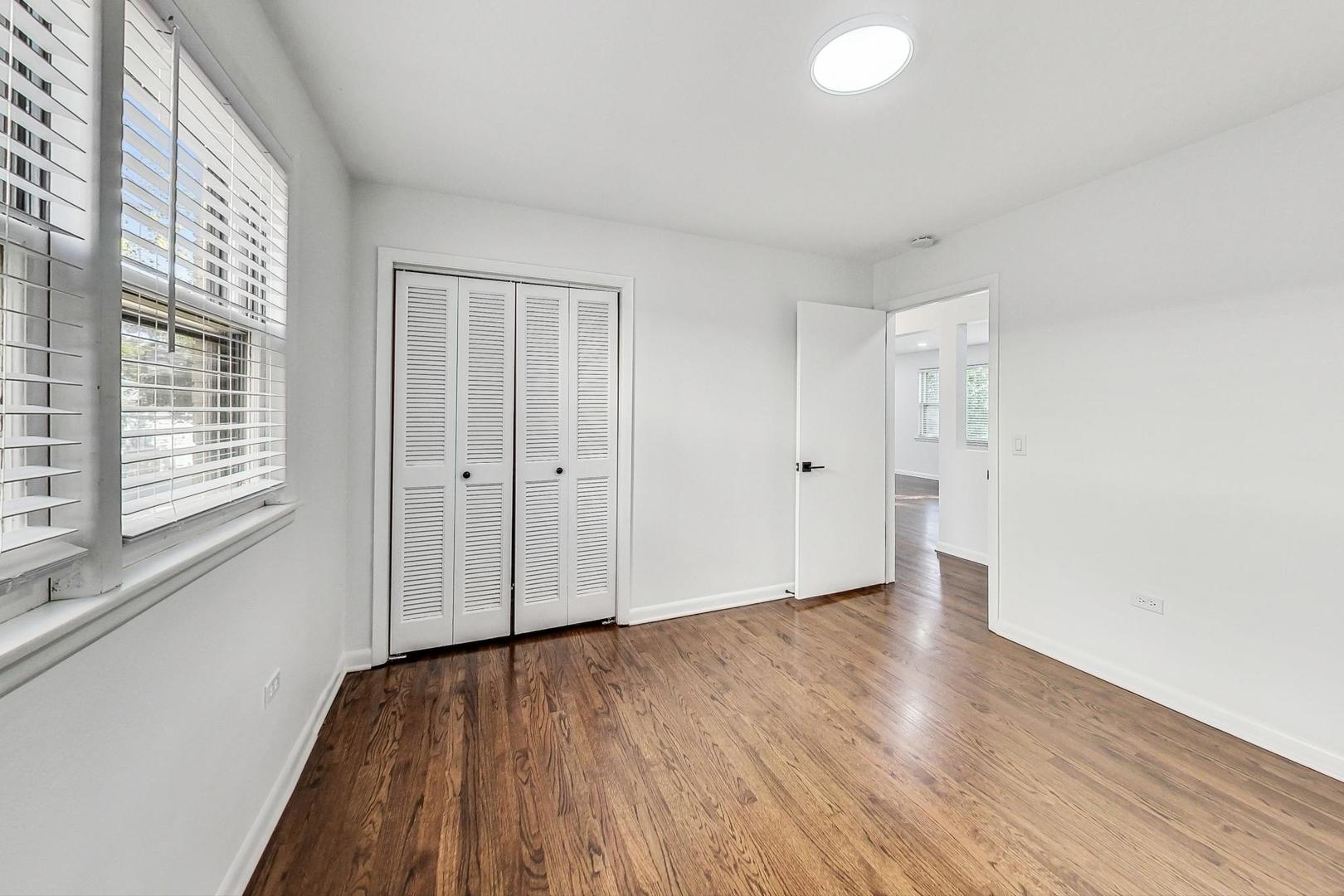 1108 Fortuna Avenue, Unit 1 Park Ridge, IL 60068 - Photo 31 of 39 a view of an empty room with wooden floor and a window