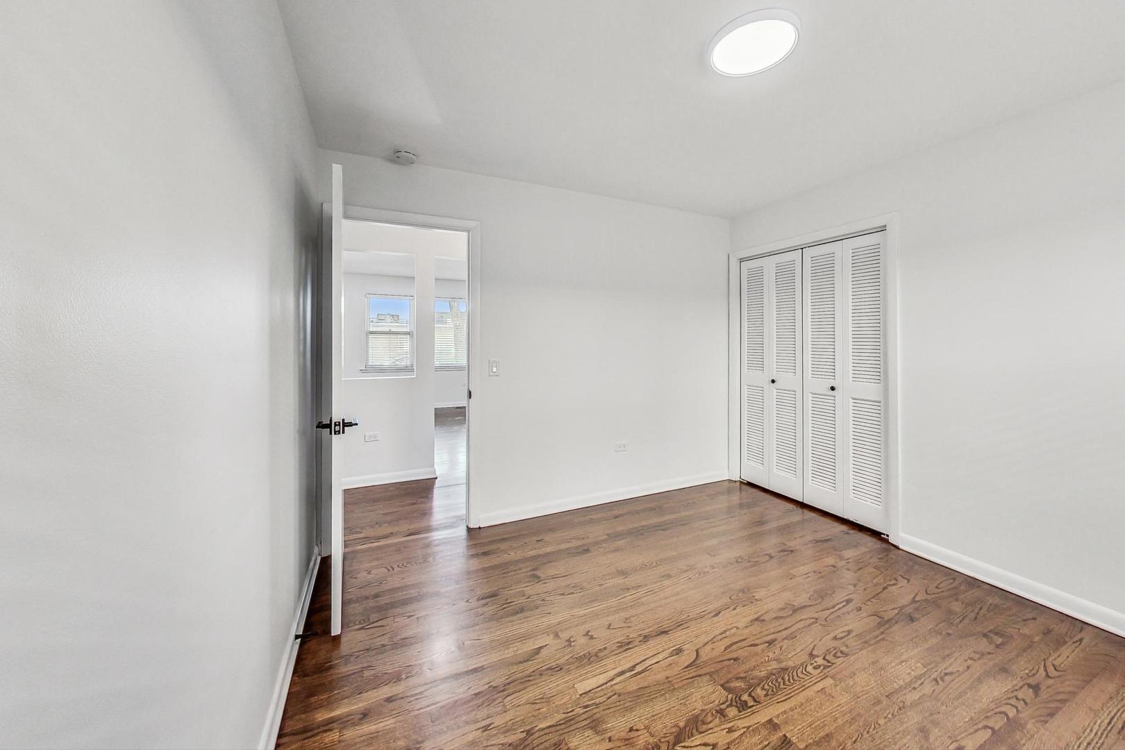 1108 Fortuna Avenue, Unit 1 Park Ridge, IL 60068 - Photo 34 of 39 an empty room with wooden floor and windows