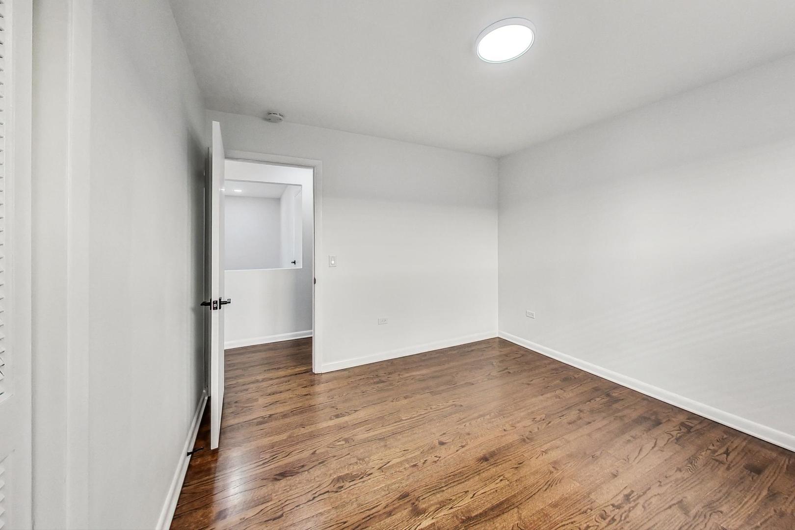 1108 Fortuna Avenue, Unit 1 Park Ridge, IL 60068 - Photo 35 of 39 an empty room with wooden floor and windows