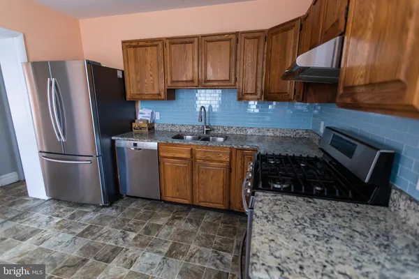 a kitchen with a sink stove and refrigerator