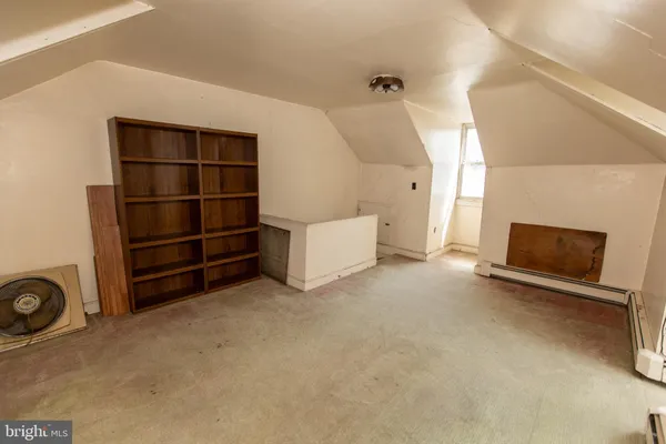 a view of an empty room with a fireplace