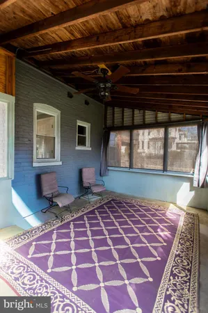 a view of an empty room with a rug