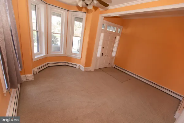 a view of an empty room and a window