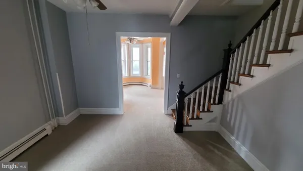 a view of a hallway with stairs