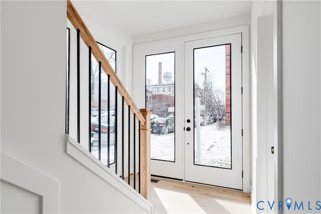 a view of a hallway with wooden floor and entryway