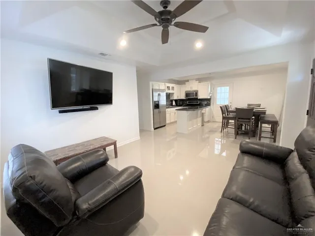 a kitchen with stainless steel appliances granite countertop a refrigerator a stove a microwave and a sink