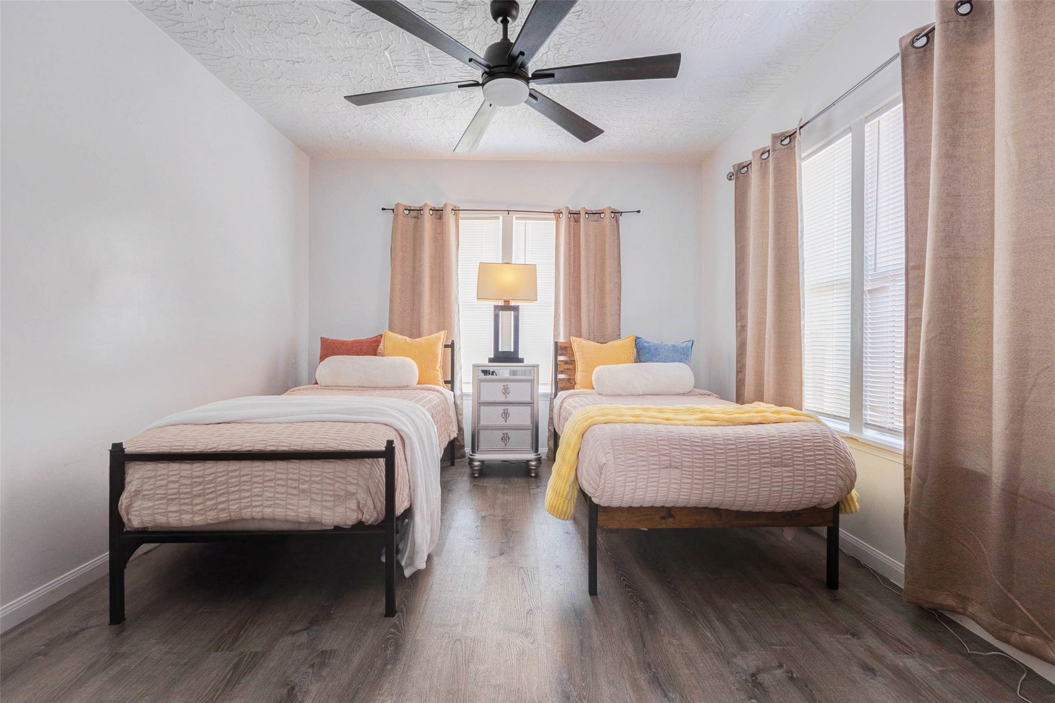 2902 Truxillo Street Houston, TX 77004 - Photo 18 of 32 a bedroom with a bed a table and a chandelier