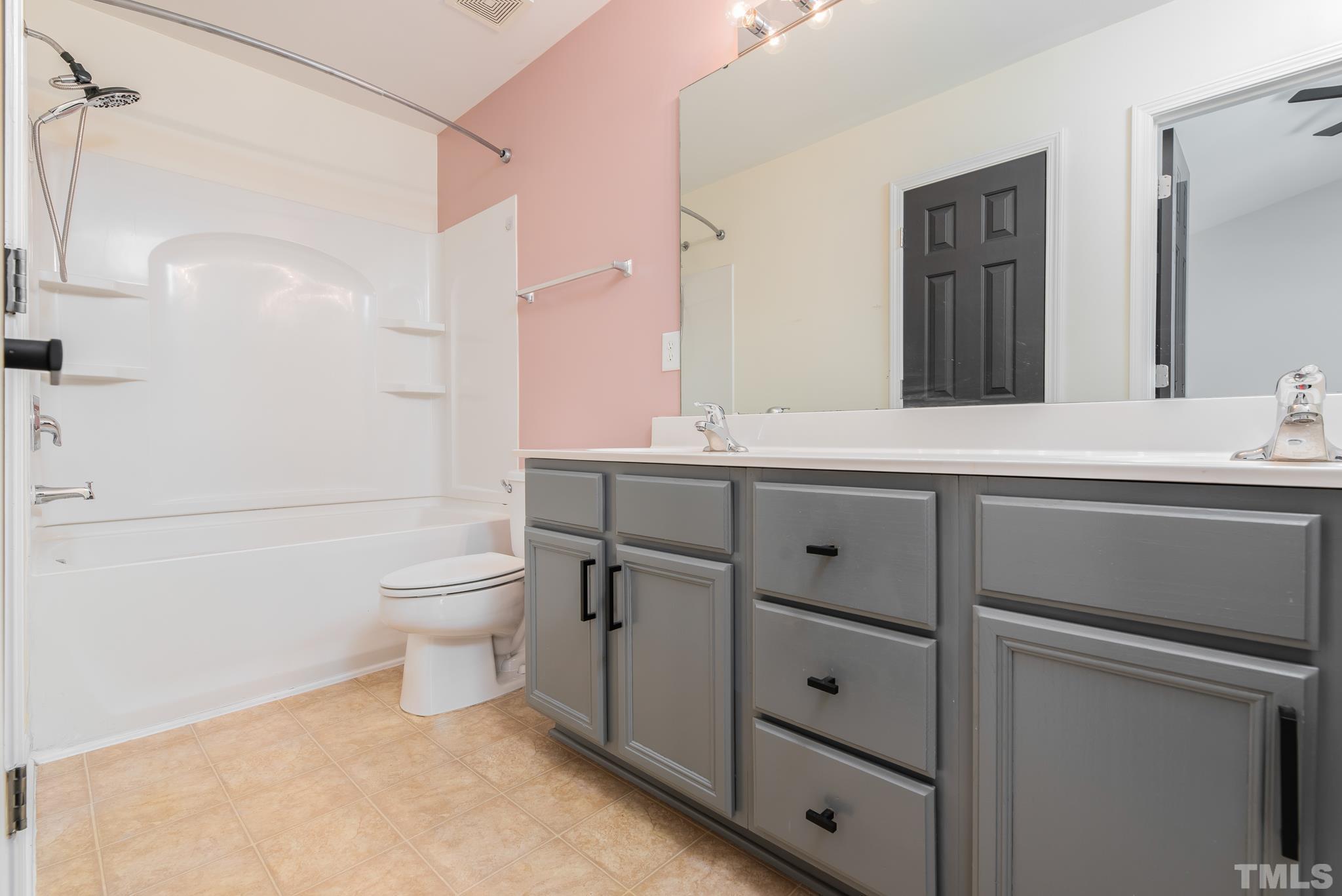 7814 Averette Field Drive Raleigh, NC 27616 - Photo 11 of 24 a bathroom with a sink toilet vanity and shower