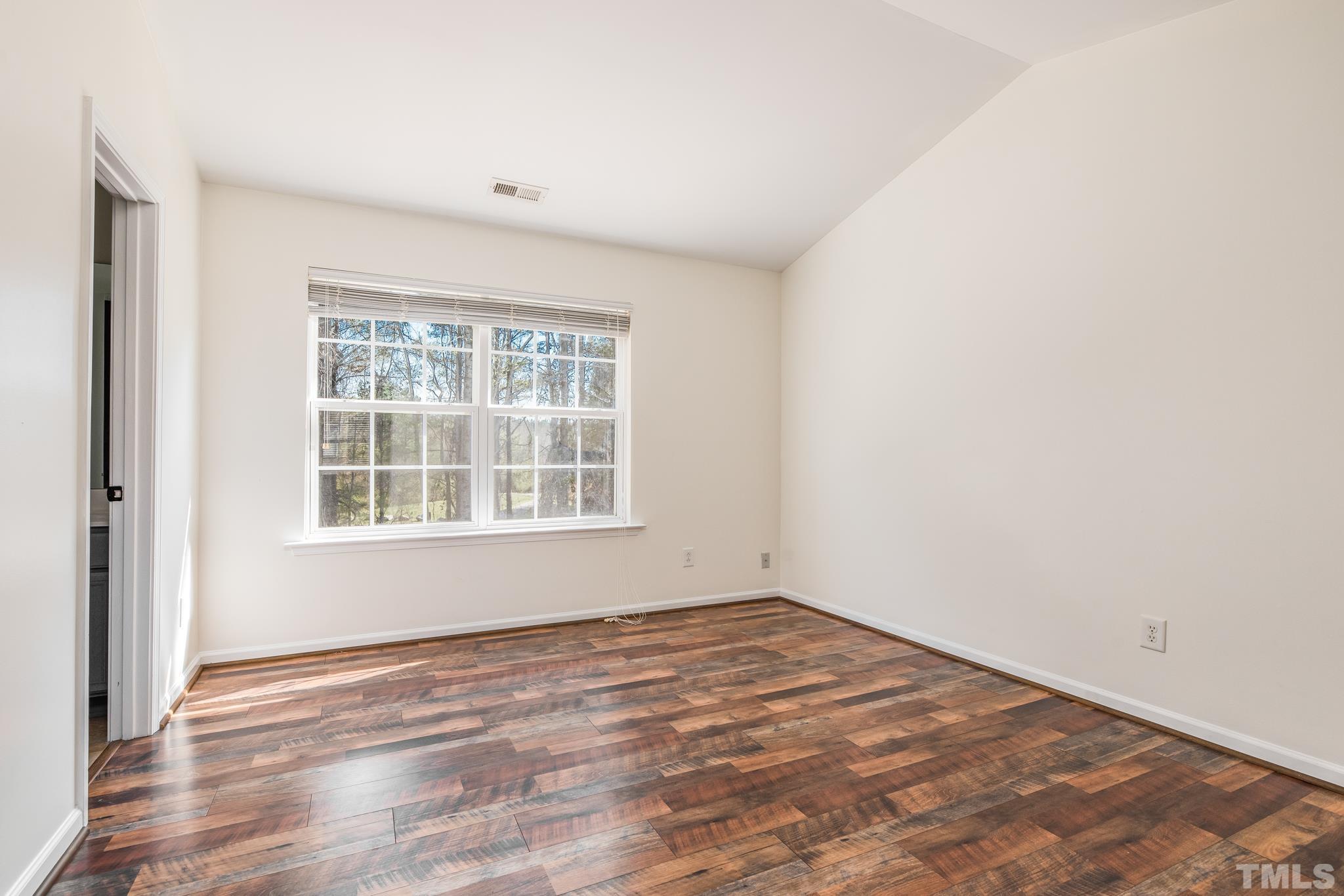 7814 Averette Field Drive Raleigh, NC 27616 - Photo 14 of 24 a view of empty room with wooden floor and fan