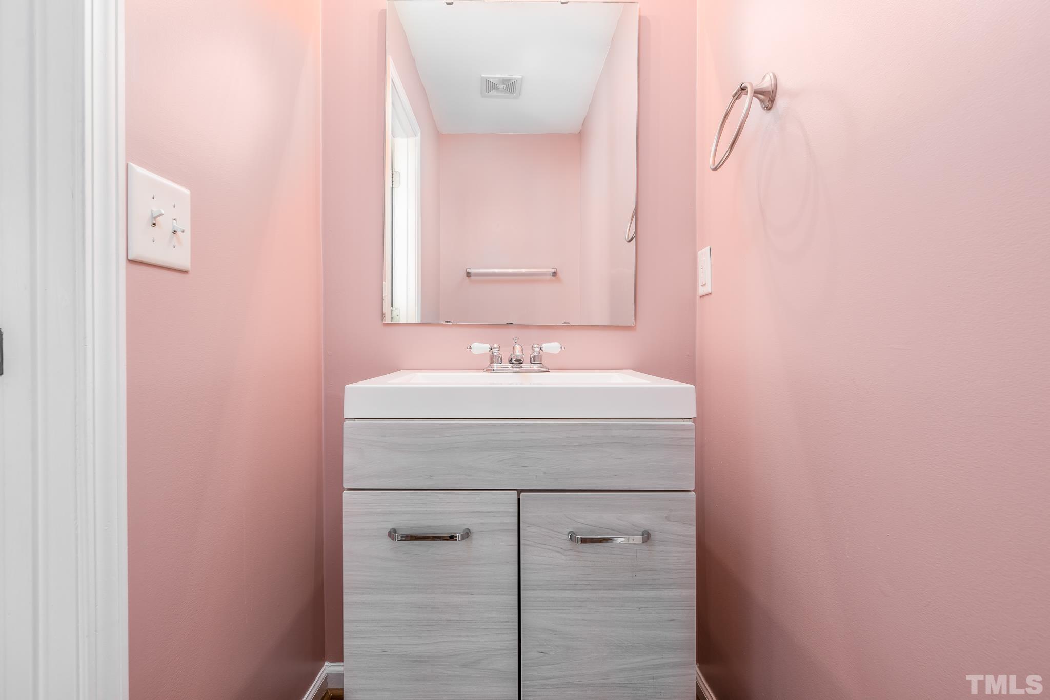 7814 Averette Field Drive Raleigh, NC 27616 - Photo 16 of 24 a bathroom with a sink and a mirror