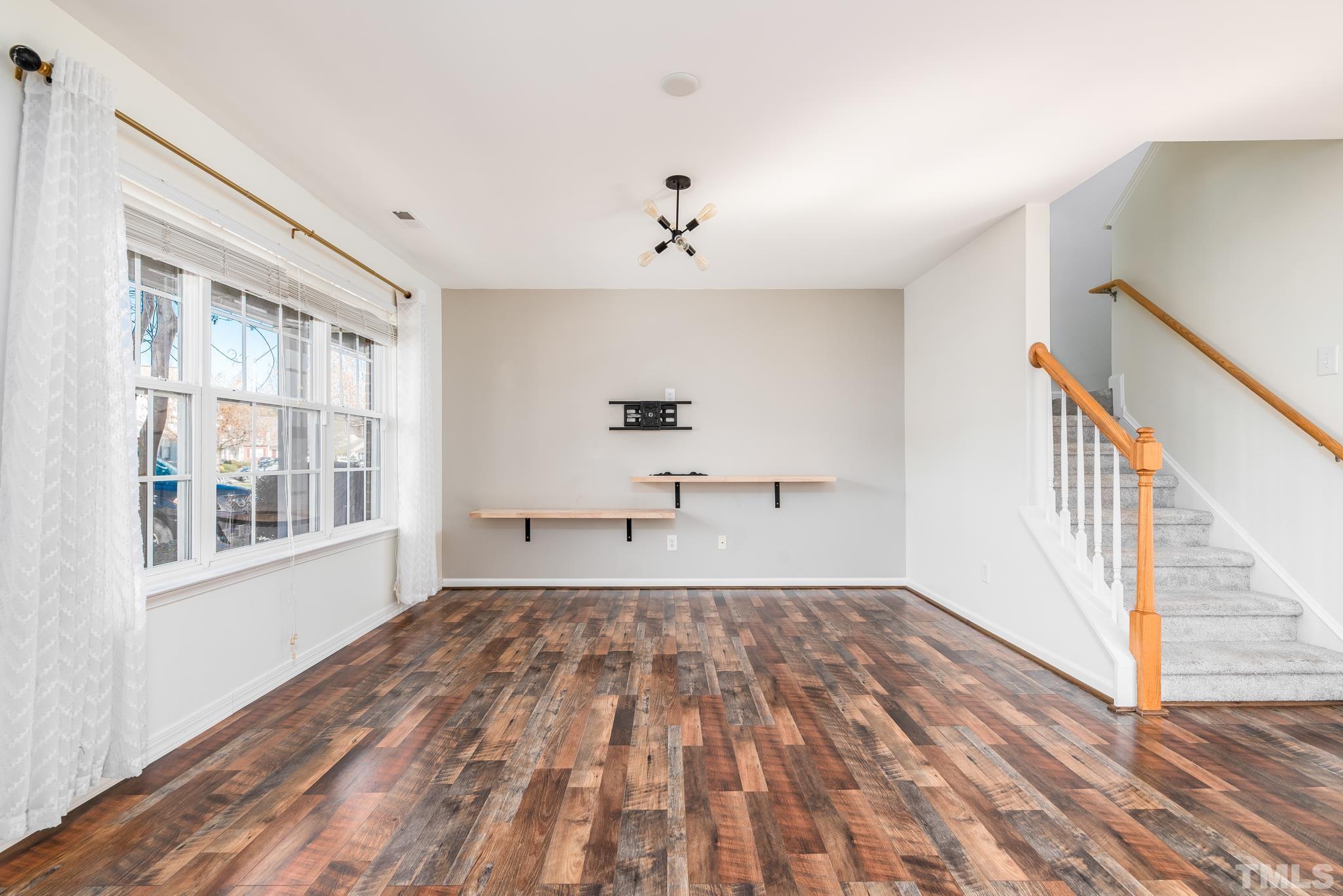 7814 Averette Field Drive Raleigh, NC 27616 - Photo 5 of 24 wooden floor in an empty room with a window
