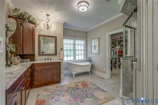 a spacious bathroom with a sink double vanity and a tub