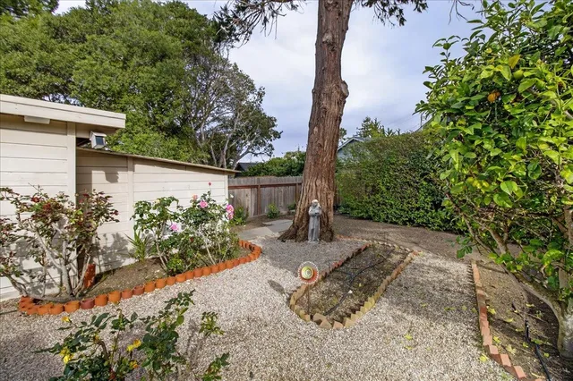 a view of a chair and table in backyard