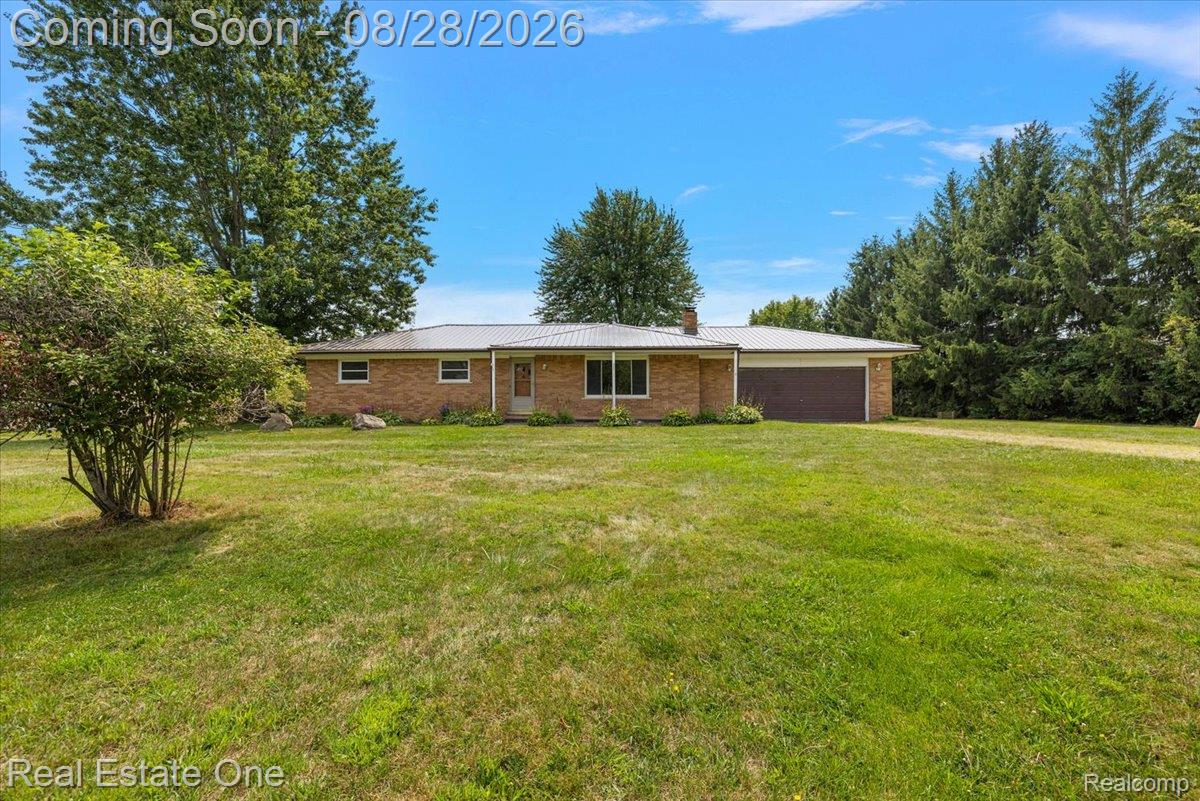 15250 34 Mile Road Armada, MI 48005 - Photo 2 of 49 Brick exterior with a metal roof, attached garage, and a gravel driveway