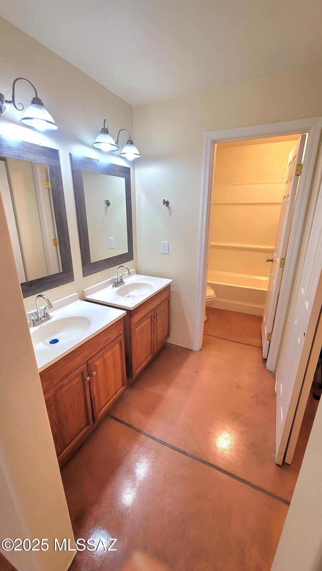 533 West San Xavier Road Tucson, AZ 85713 - Photo 11 of 21 a bathroom with a sink a vanity and mirror