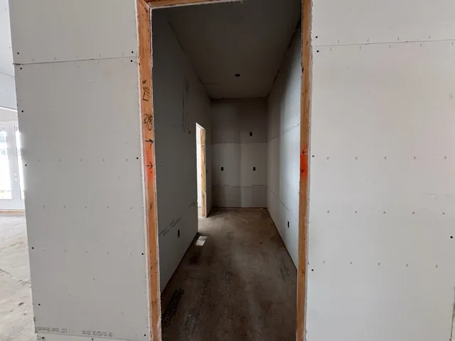 a small space with wooden floor and a window