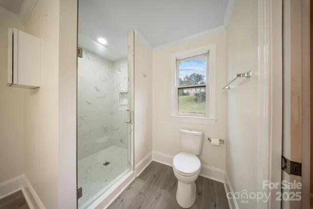 a bathroom with a toilet and a shower