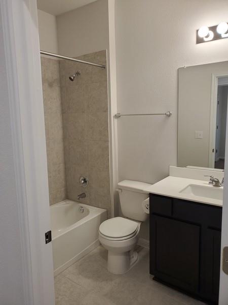 6404 Gunflint Drive Austin, TX 78747 - Photo 6 of 21 A well-appointed bathroom featuring a clean, white bathtub and a modern vanity with ample counter space.