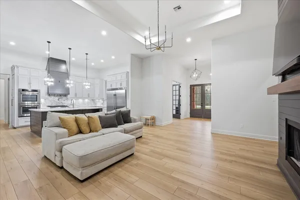 a living room with furniture a flat screen tv and a fireplace