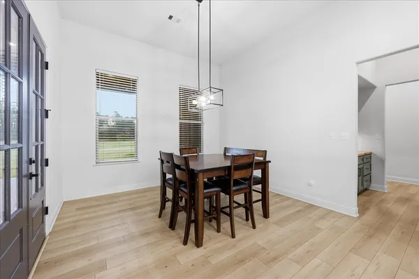 a kitchen with kitchen island granite countertop a stove oven and a view of living room