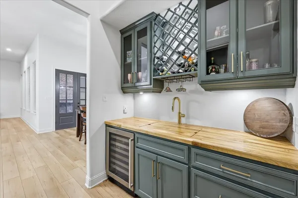 a kitchen with stainless steel appliances kitchen island a wooden floor and refrigerator
