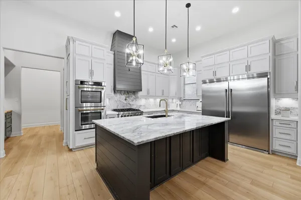 a kitchen with stove and cabinets