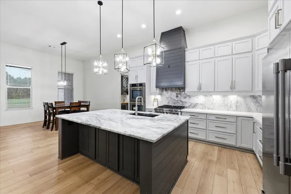 a kitchen with sink and center island