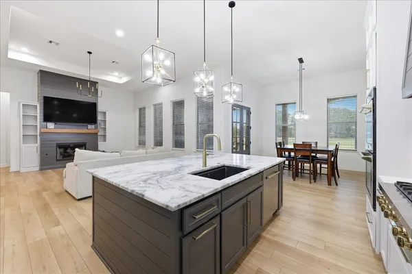 a view of a kitchen with a sink and a refrigerator