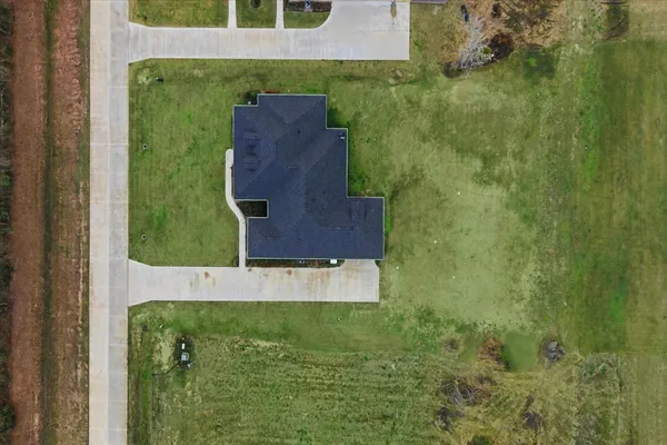 an aerial view of residential houses with outdoor space and river