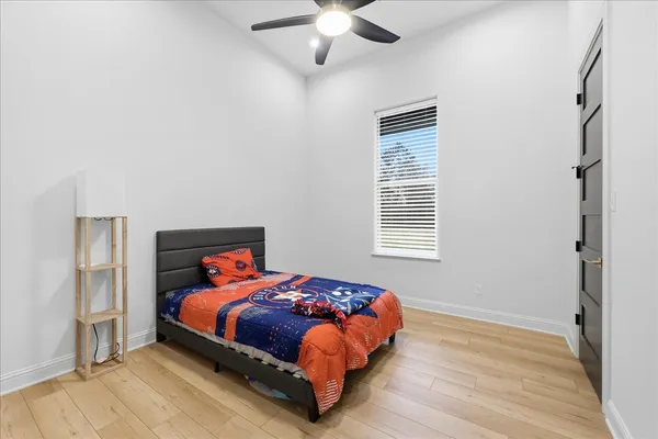 an empty room with closet and chandelier fan