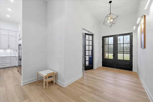a view of a livingroom with a hardwood floor and a ceiling fan