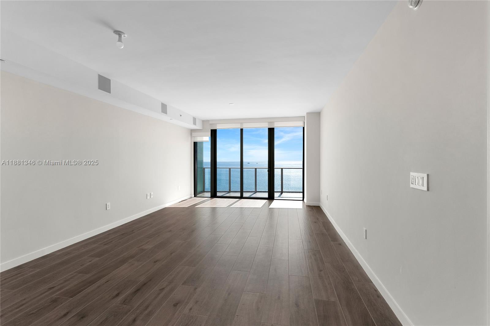 1116 North Ocean Boulevard, Unit 1404 Pompano Beach, FL 33062 - Photo 11 of 80 wooden floor in an empty room with a window