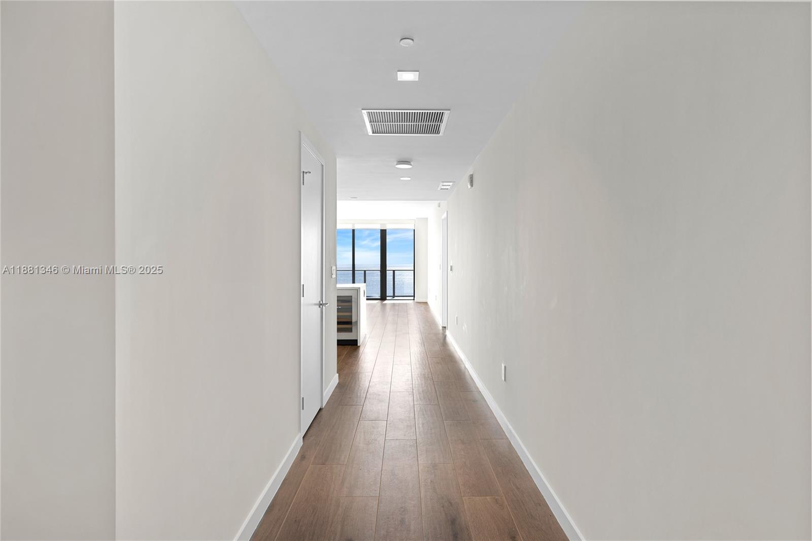 1116 North Ocean Boulevard, Unit 1404 Pompano Beach, FL 33062 - Photo 22 of 80 a view of a hallway with wooden floor