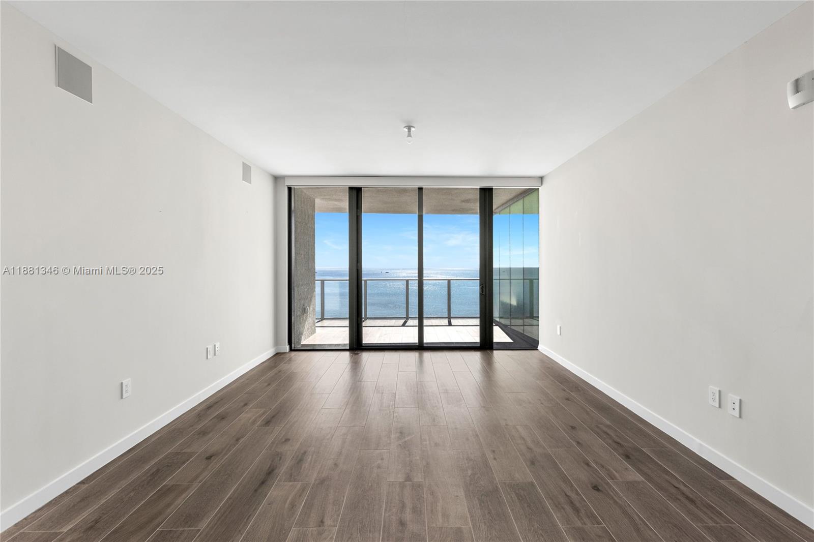 1116 North Ocean Boulevard, Unit 1404 Pompano Beach, FL 33062 - Photo 24 of 80 wooden floor in an empty room with a window