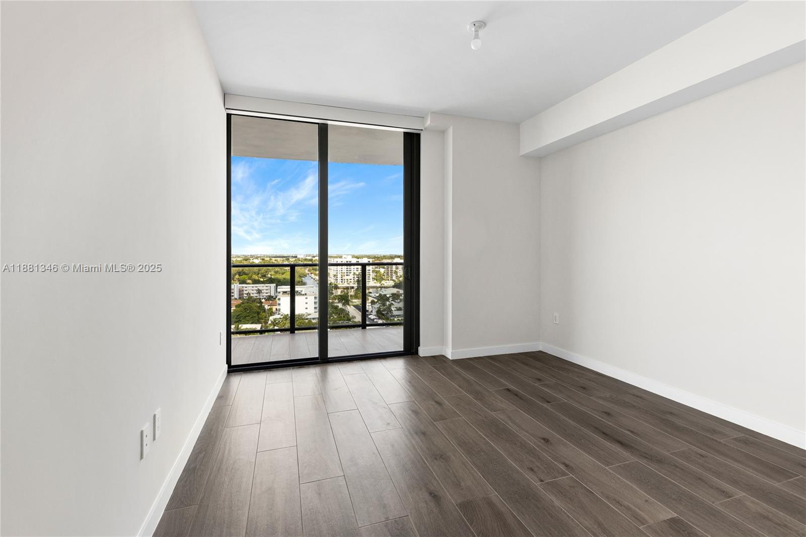 1116 North Ocean Boulevard, Unit 1404 Pompano Beach, FL 33062 - Photo 41 of 80 wooden floor in an empty room with a window