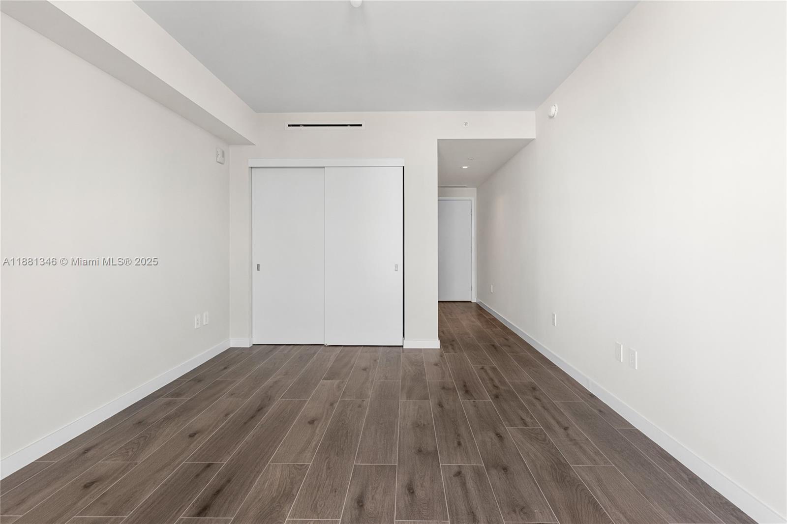 1116 North Ocean Boulevard, Unit 1404 Pompano Beach, FL 33062 - Photo 55 of 80 a view of an empty room with wooden floor