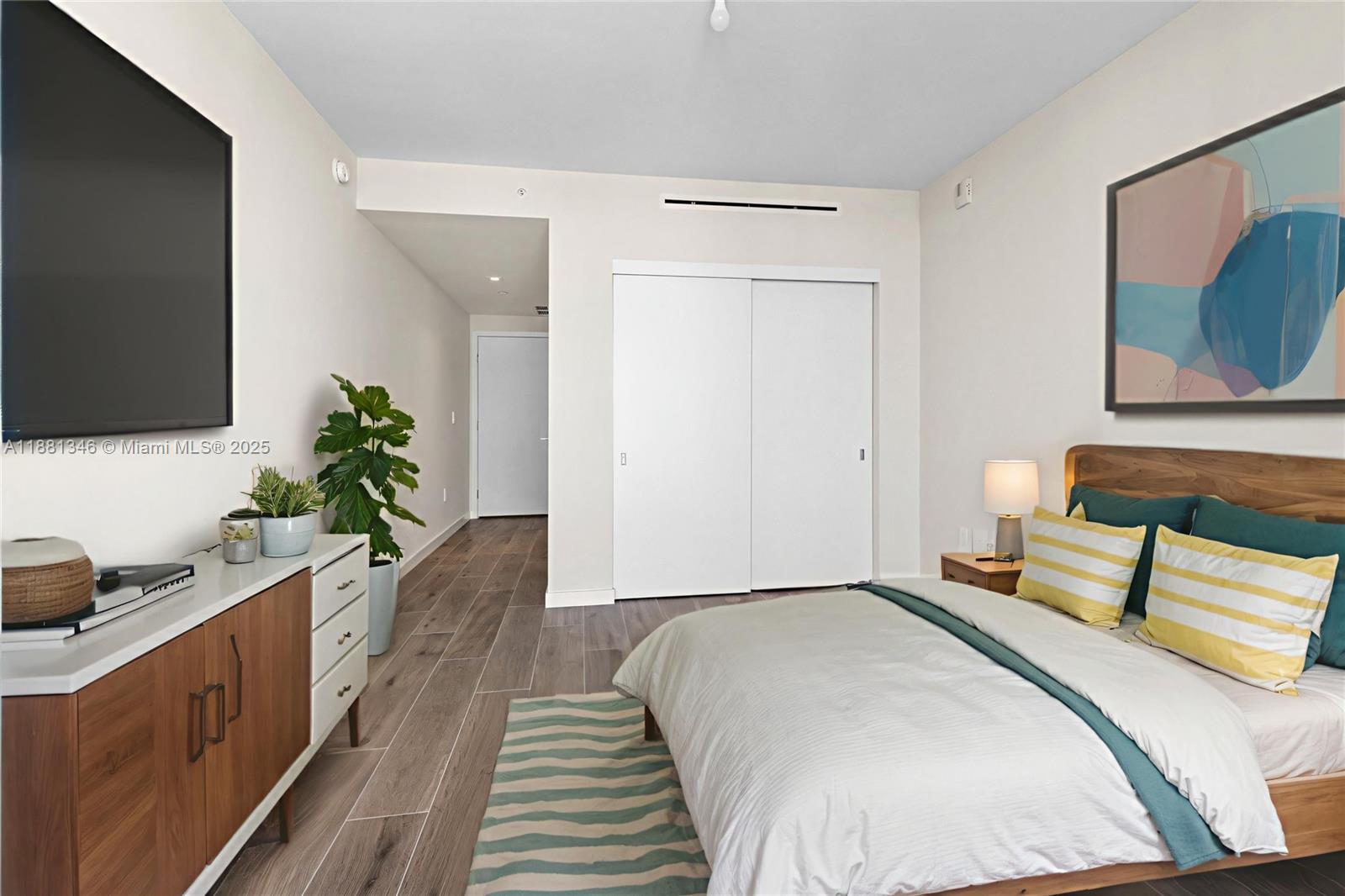 1116 North Ocean Boulevard, Unit 1404 Pompano Beach, FL 33062 - Photo 79 of 80 a bedroom with a bed and a flat screen tv