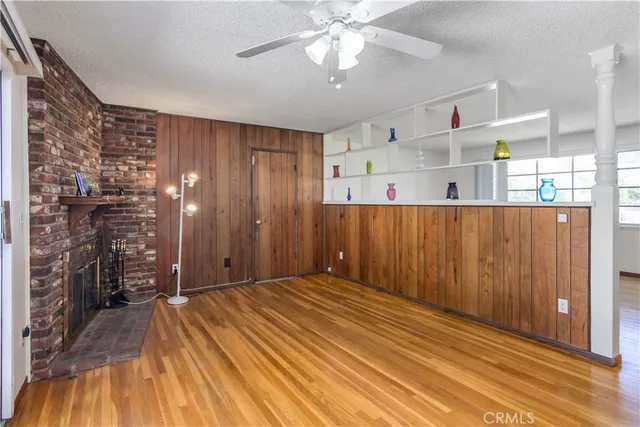 a view of a livingroom with a furniture and chandelier fan