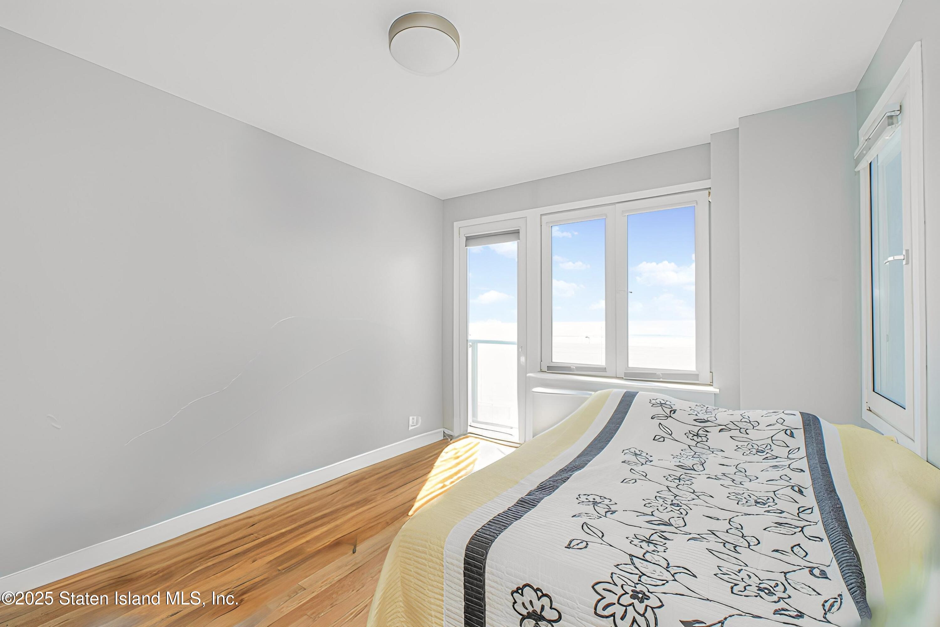 130 Beach 119th Street, Unit 3B Queens, NY 11694 - Photo 17 of 29 a bedroom with a bed and a window