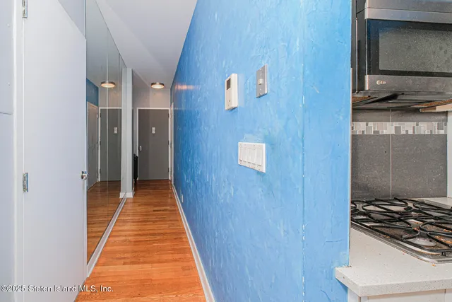 a kitchen with stainless steel appliances granite countertop a stove and a wooden cabinets