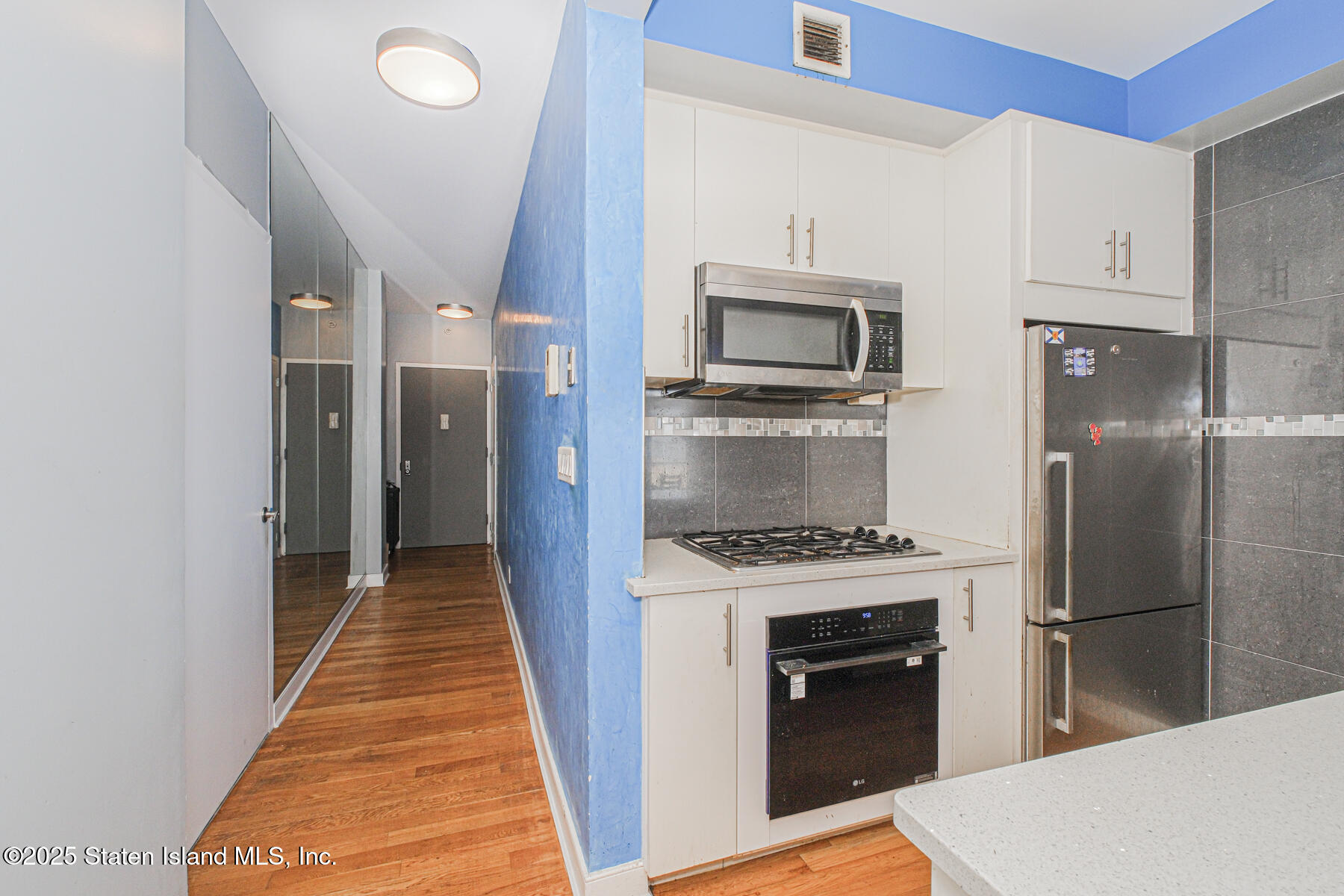 130 Beach 119th Street, Unit 3B Queens, NY 11694 - Photo 21 of 29 a kitchen with granite countertop a stove and a refrigerator