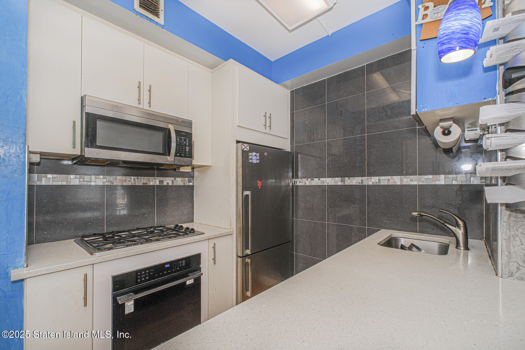 130 Beach 119th Street, Unit 3B Queens, NY 11694 - Photo 23 of 29 a kitchen with a stove and a microwave