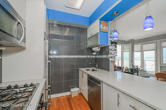 a kitchen with a sink appliances and cabinets