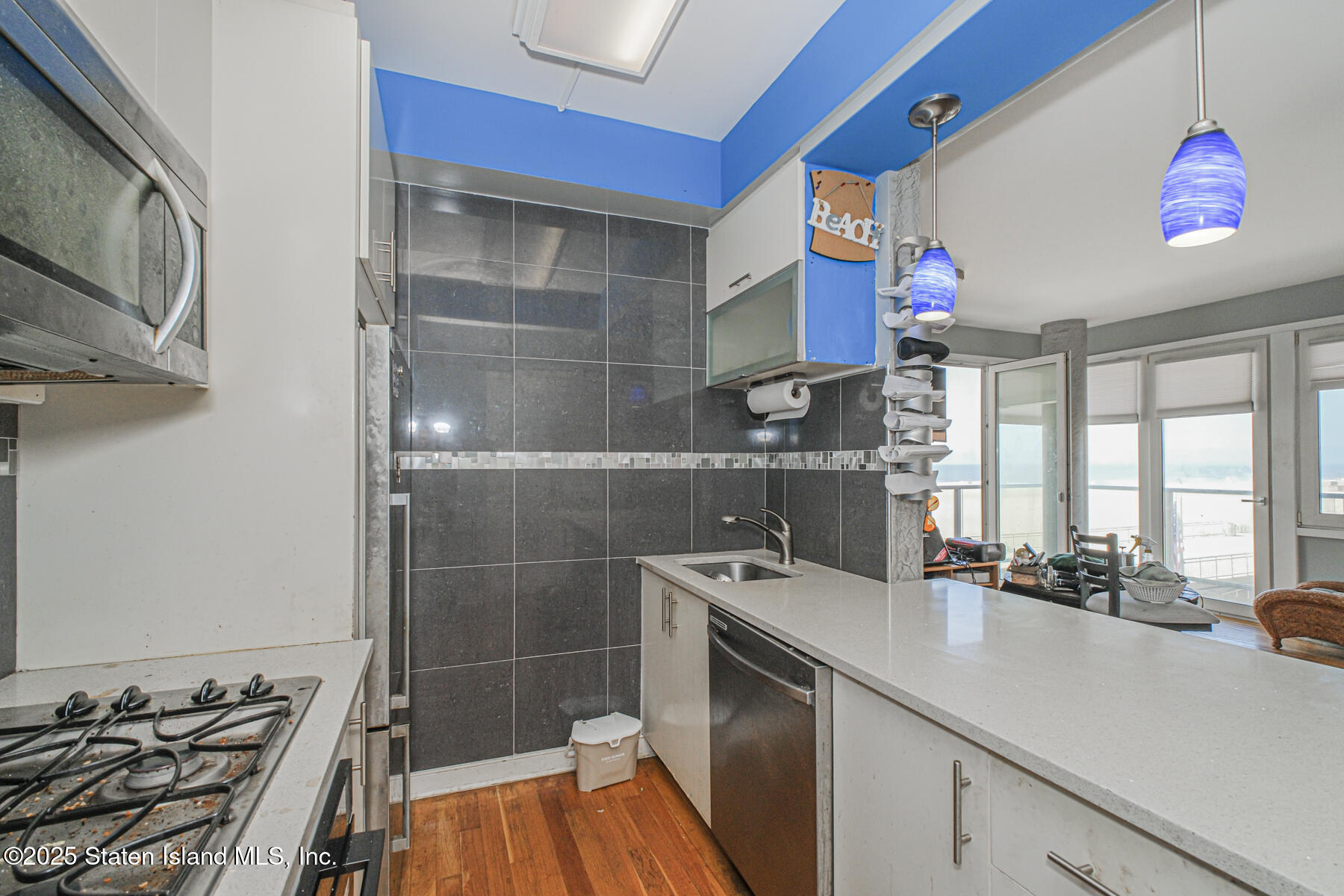 130 Beach 119th Street, Unit 3B Queens, NY 11694 - Photo 24 of 29 a kitchen with a sink appliances and cabinets